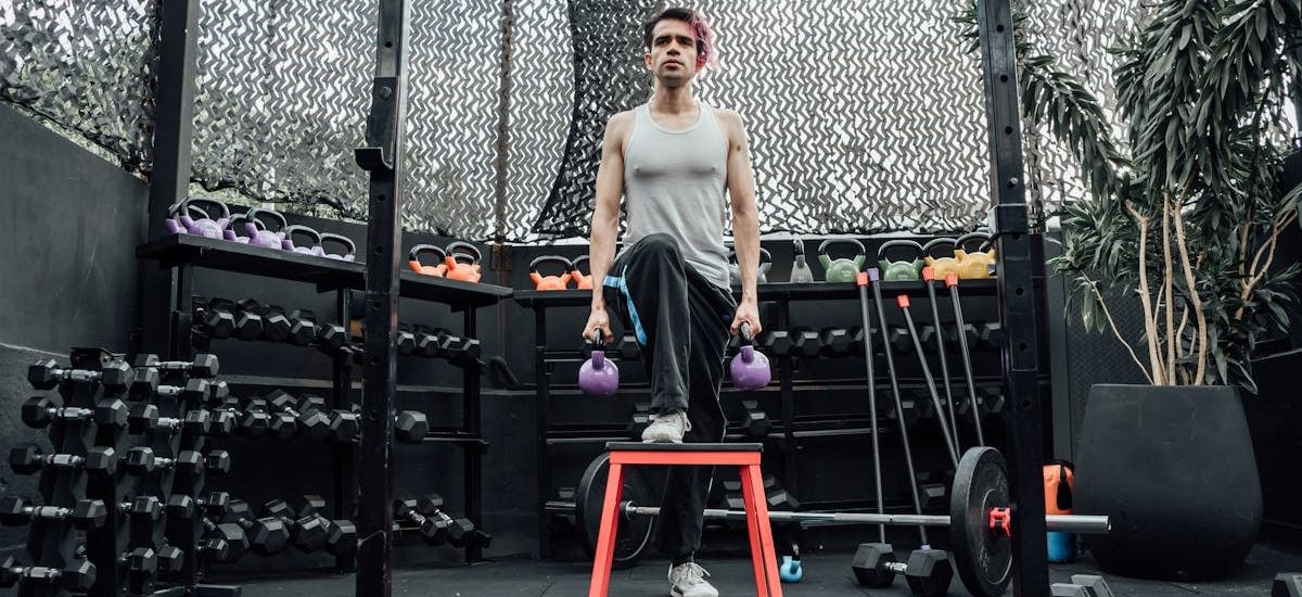 Adult male performing kettlebell exercises in a modern Mexico City gym.