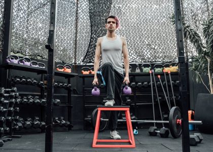 Adult male performing kettlebell exercises in a modern Mexico City gym.